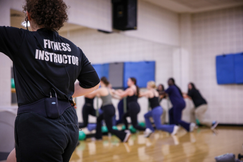 group fitness instructor with participants in the background