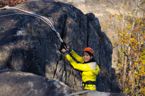 Student rock climbing during an adventure trip