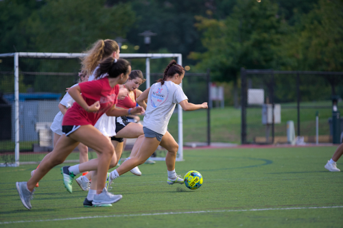 Students playing intramural soccer on an outdoor field