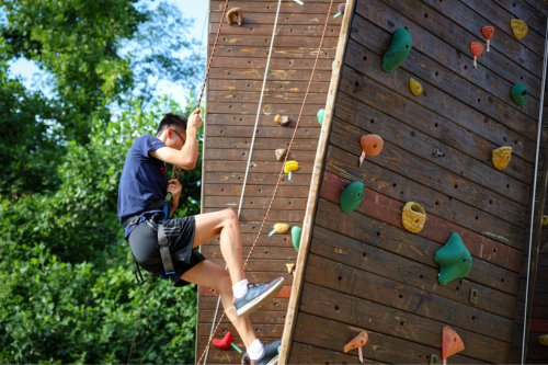 Student climbing at the RecWell climbing wall