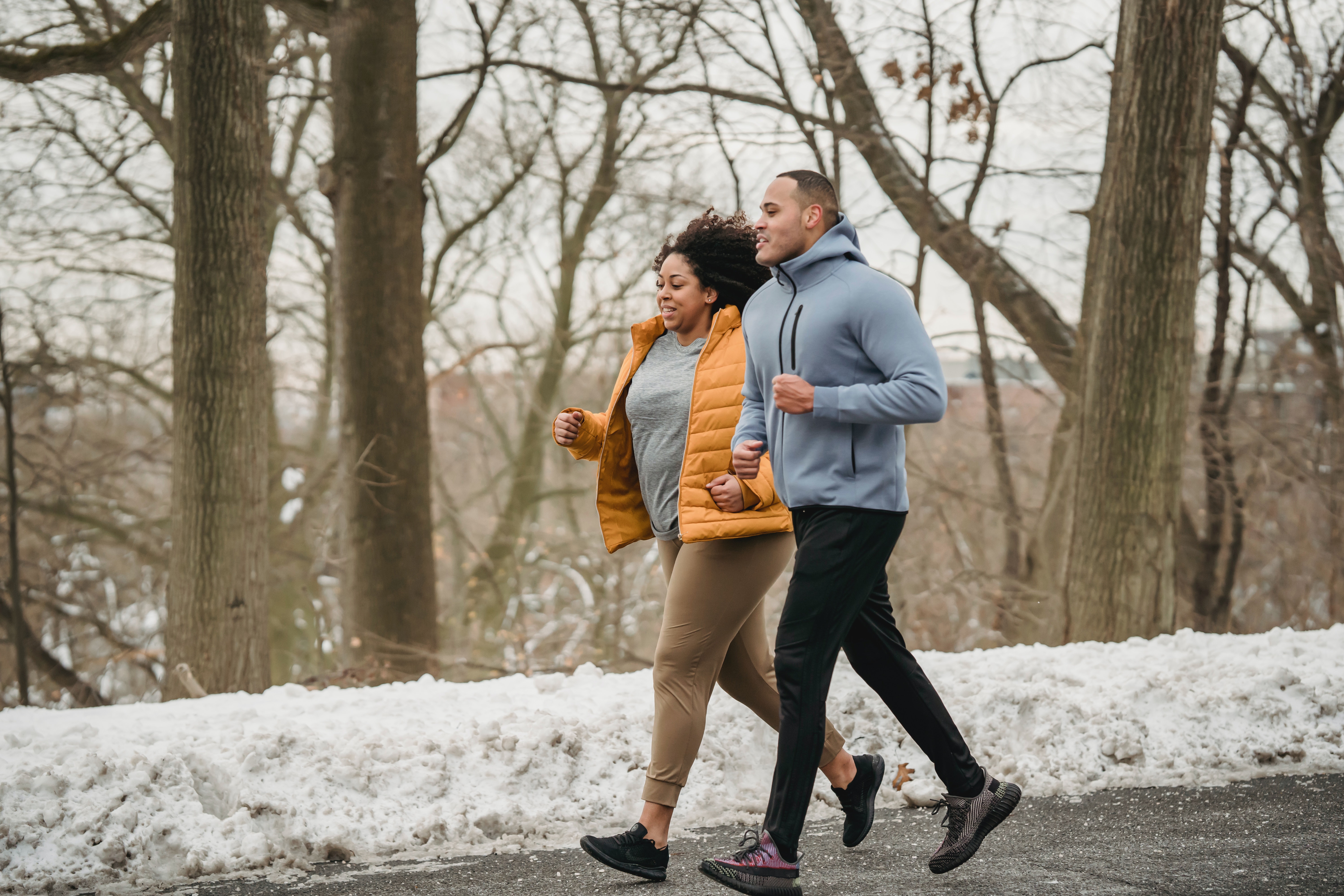 black couple running outdoors cold weather