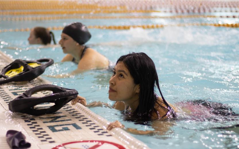 aqua fitness participant holding on to the side of the pool