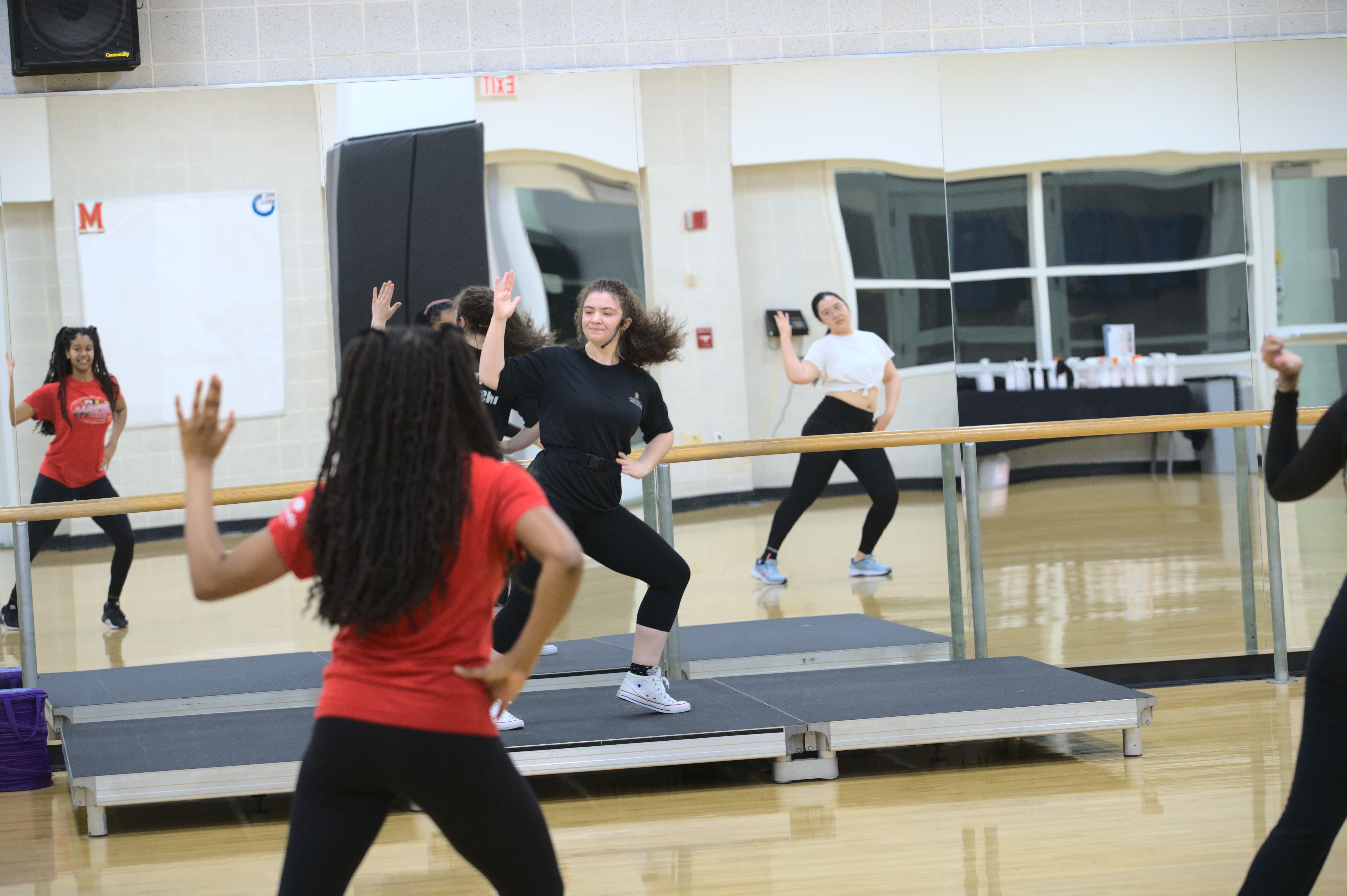 group fitness instructor leads a dancefit class