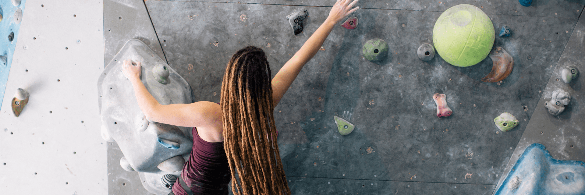 woman climbing bouldering wall