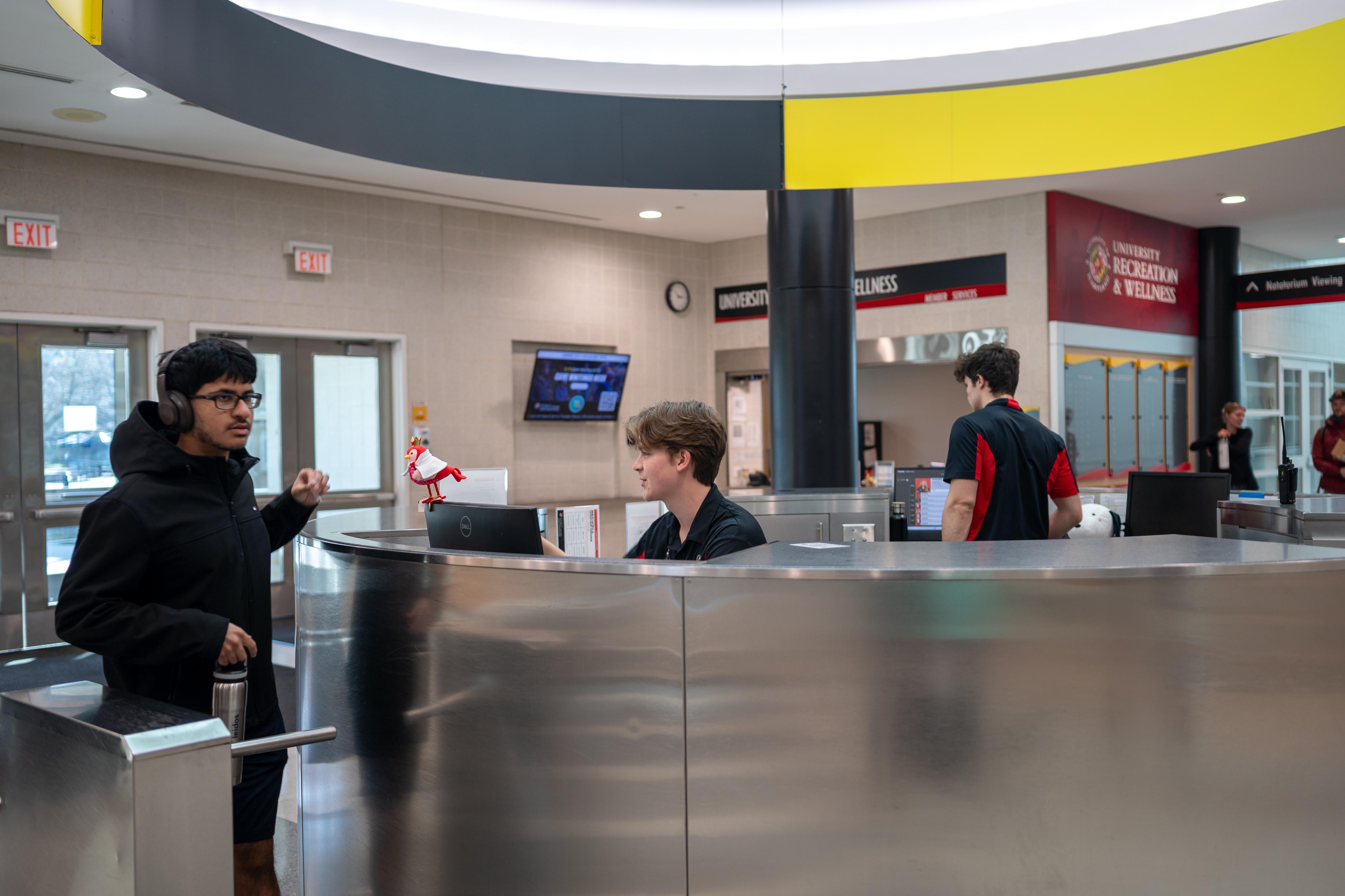 North Campus Facilities Student Employees welcome a patron into Eppley Recreation Center at the Information Desk.