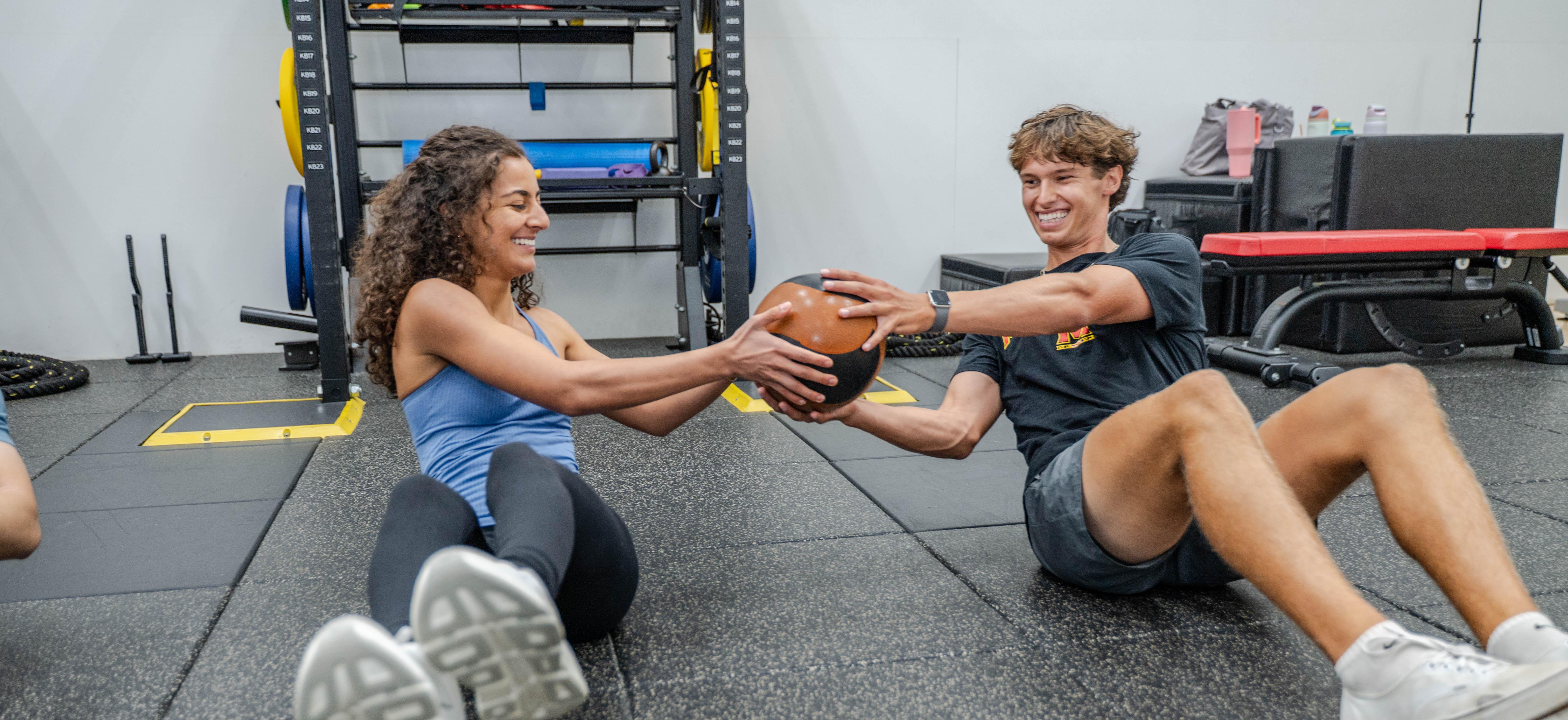 man and woman doing russian twists together